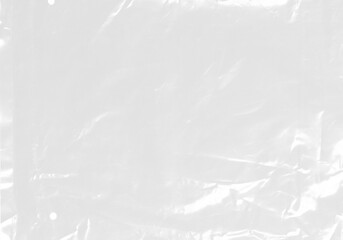 Obraz premium plastic transparent cellophane bag on white background. The texture looks blank and shiny. The plastic surface is wrinkly and tattered making abstract pattern