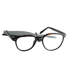 Eyeglasses with tortoiseshell frames rest on a black background.