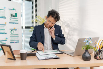 Naklejka premium A confident businessman calculating budget and reviewing company performance using reports and charts in a clean modern office, focusing on financial goals, investments, and strategic success.