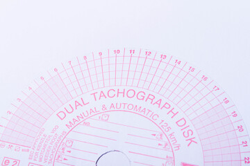 Tachograph. Driver time tracking. Fixing the movement of the car. Cargo transportation with driving according to the schedule. Time disk. Background from recorded analog tachograph disks.