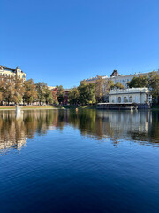 Obraz premium Patriarch's Ponds on an autumn sunny day and a pavilion with a cafe and the sun, Moscow
