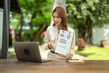Businesswoman presenting data chart during outdoor video call