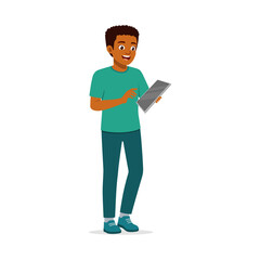 Young African American Man Standing Holding and Using a Tablet with a Smiling Expression