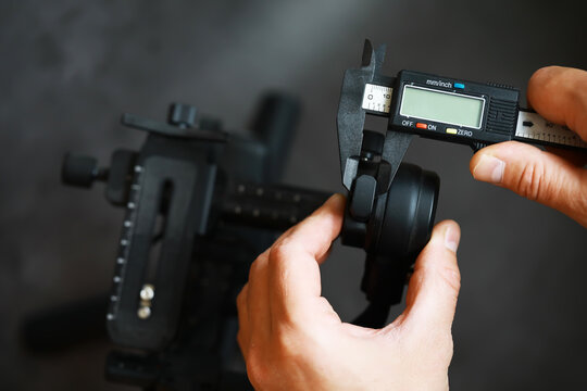 Precision Measurement in Engineering: Close-Up of Digital Caliper in Use by Technician