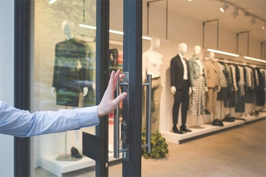 customer push door to enter fashion clothing store