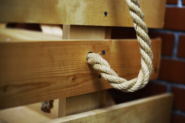 Rustic Wooden Swing with Rope on Red Brick Wall for Outdoor Playful Decor