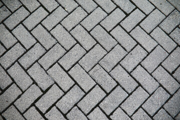 Herringbone Pattern: Close-Up View of Gray Paving Bricks for Urban Landscapes