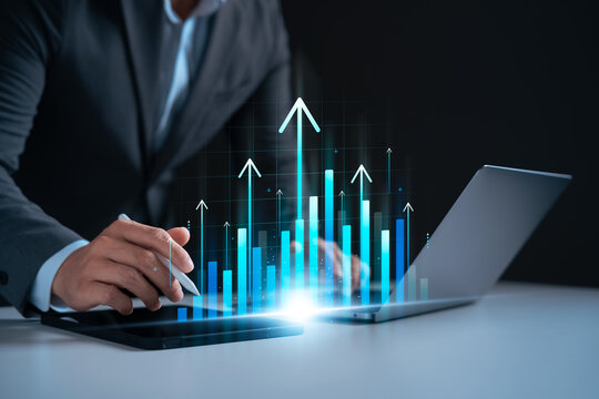 Investment and business growth concept with upward bar charts and arrows. Businessman analyzing financial performance using digital technology for profit, strategy, and economic success. - Powered by Adobe