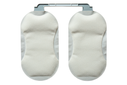 Pair of disposable underarm sweat pads on a plastic hanger on a transparent background