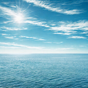 Bright sun shining over calm blue ocean waters and sky