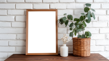 Empty white picture frame on wooden shelf against white brick wall