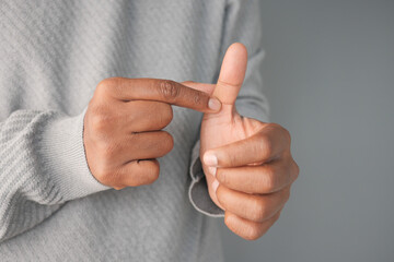 closeup of man suffering pain on his finger 