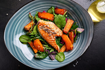 Wholesome salmon dish with greens and sweet potatoes encouraging healthy habits in young minds
