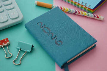 2026 Journal and stationery items on a colorful desk surface