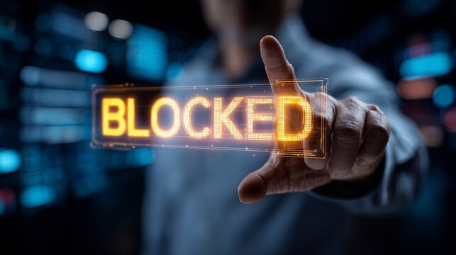 A man in a blue shirt points at a glowing 'BLOCKED' sign, symbolizing security or access denial in a digital environment.