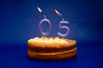 Birthday card with candle and cake: number zero five on a blue background.