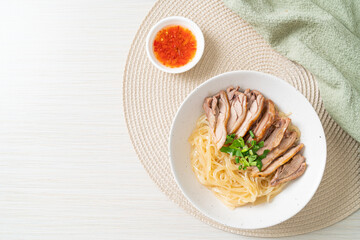 dried noodles with stewed duck in white bowl