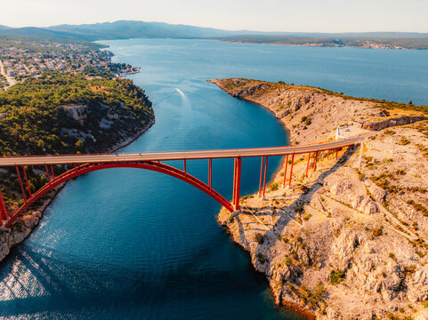 Maslenica Bridge spanning the Novsko zdrilo strait on Croatia&rsquo;s Adriatic coast. Red steel structure  with the turquoise sea and rugged cliffs near Zadar and Paklenica and Velebit national park