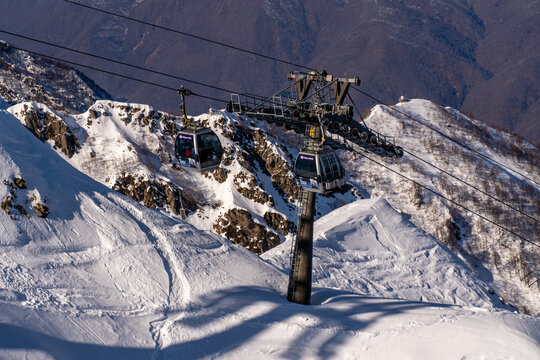 SkiLift, Mountain, Winter: Aerial view of ski lift infrastructure on snowy mountain peak during winter season for recreational skiing.