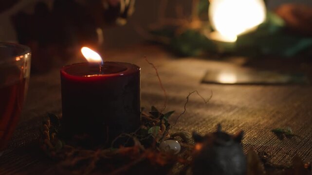 Fortune teller performing a mystical ritual, spreading tarot cards on a wooden table, surrounded by a lit candle and other esoteric objects for divination and spiritual guidance