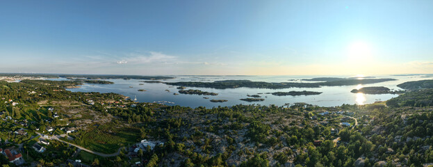 Panoramic Aerial View of Coastal Archipelago Near Str&ouml;mstad, Sweden with Forested Terrain, Scattered Islands, and Sunlight Reflecting on Calm Sea
