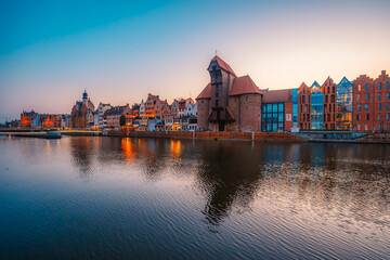 Gdansk with Motlawa river in Poland. Old town colourful house with Zuraw or crane and with Holy Spirit Gate