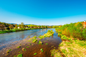 Peak Tri Koruny or Trzy Korony during day with green meadow and trees in spring. Pieniny National park in Slovakia and Poland © Zedspider