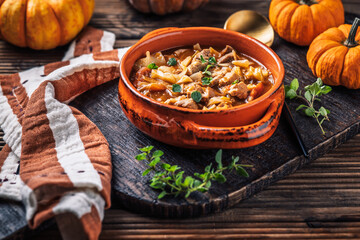 Warm stew with meat, cabbage and pumpkin, comfort autumn dinner balanced food
