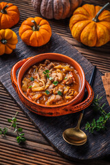Warm stew with meat, cabbage and pumpkin, comfort autumn dinner balanced food