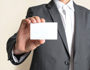 Businessman presents blank white business card in a professional setting, offering opportunity for connection and networking, conveying trust and potential success.