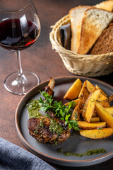 Lamb chop with potato wedges and red wine