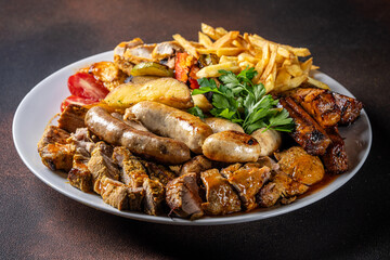 Mixed grilled meat platter with sausages and fries
