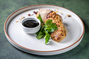 Grilled chicken breast with dark sauce