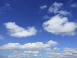 Bright Sunny Blue Sky with Fluffy White Cumulus and Cirrus Clouds on a Clear Day.
