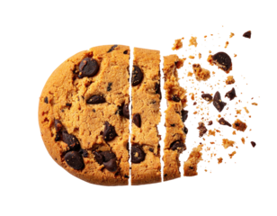A chocolate chip cookie breaks apart into crumbs against a black background