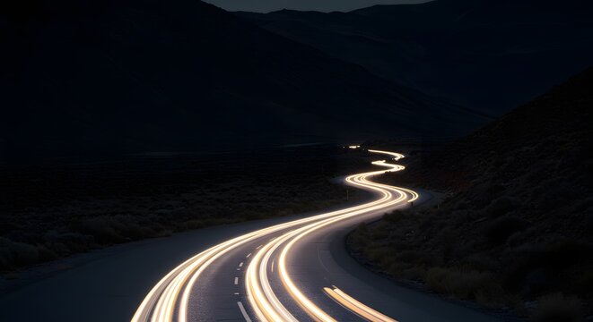 A dark mountain road, illuminated by long exposure car light trails