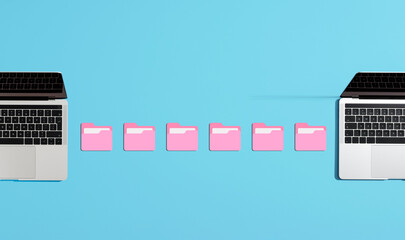 File transferring between laptops using pink folders on blue background