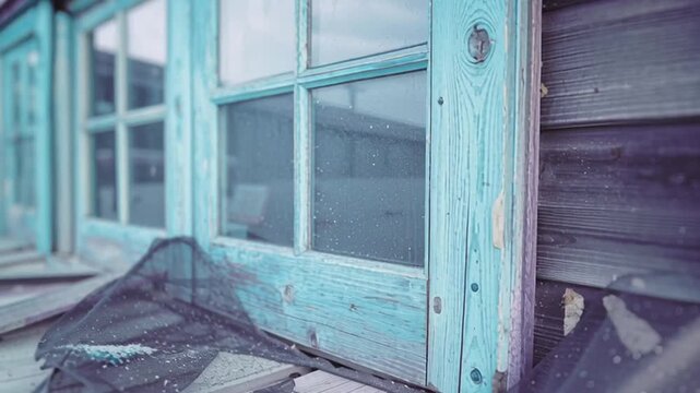 Weathered turquoise window frame with peeling paint wooden cottage porch and torn insect mesh aged seaside shack, nostalgic coastal decay