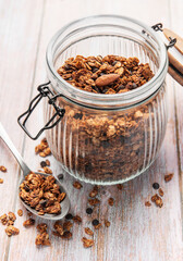 Granola cereal with chocolate and almonds in jar