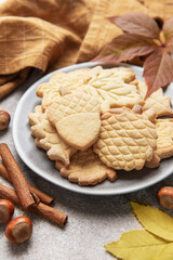 Autumn cookies on plate with cinnamon and hazelnuts