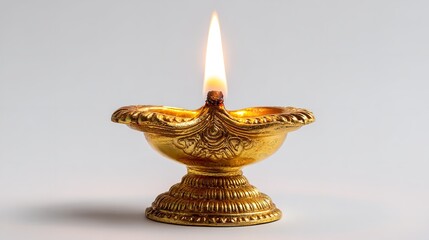 Golden diya lamp glowing with bright flame isolated on white background, symbol of diwali festival