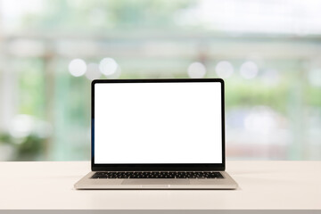 Fototapeta premium close up blank white screen display of laptop computer on table in office building with garden scene for add content of design banner,website or template or online shopping e-commerce concept