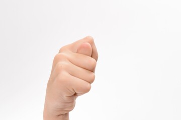 Close-up of a hand making a fist, thumb tucked inside. Isolated on a white background.