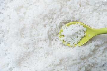 close up flower of sea salt crystals and spoon, food concept.