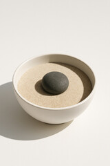 Minimalist White Ceramic Bowl Filled with Pure Dry Sand Single Perfect River Stone