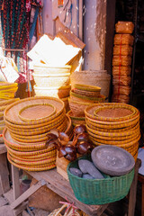 handwoven rattan and bamboo trays at traditional market booth in Cirebon, Indonesia. crafted piece reflects local craftsmanship and sustainable material culture. traditional Indonesian handicrafts.