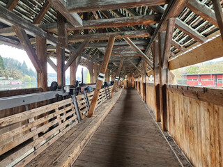 The Scherzligschleuse, or Obere Schleuse covered bridge, in Thun, Switzerland, serves as a sluice gate to control the flow of the Aare River. The bridge connects the town to the island of Balliz