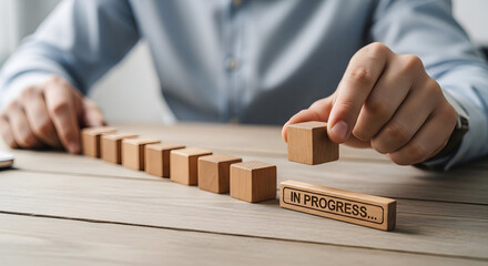 Business progress visualization with hand placing wooden block on desk