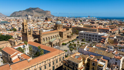 Fototapeta premium City skyline of Palermo, Sicily, Italy. In the foreground is the city's cathedral in the historic center. In the background is the port on the Tyrrhenian Sea.