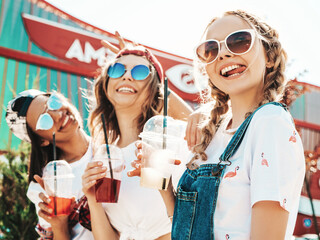 Three young beautiful smiling hipster female in trendy summer clothes.Sexy carefree women posing...